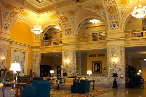 A living room filled with furniture and large windows