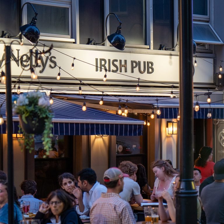 a white plate topped with a salad covered in shrimp